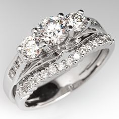 three stone engagement ring set with diamonds on the sides and side stones in white gold