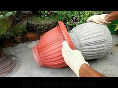 a person in white gloves is cleaning a red ball