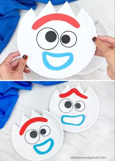 two paper plates with faces painted on them, one is blue and the other is red