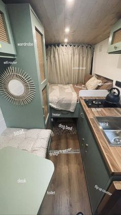 the inside of a small camper with wood flooring