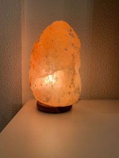 a large rock sitting on top of a table next to a light that is turned on