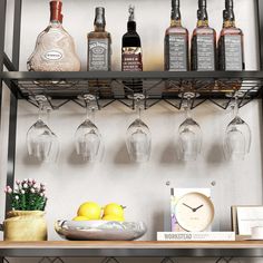 there are many bottles and glasses on the shelf next to each other with lemons