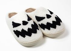 Step up your slipper game with these adorable Black & White Pumpkin Slippers! Made of soft and cozy fabric with a rubber sole, these snazzy slip-ons make a statement while keeping your feet warm. Perfect for fall festivities or just lounging around the house! Great for all genders. Details: Plush Top Sizes: 6-11 Color: black outside and pink inside. Sole: Rubber Material: Faux Fur, Fleece Lining Use: Perfect all-day use around the house. Care: Spot clean and air/hang dry. Comfy White Slippers With Textured Footbed, Playful Winter Slip-on Slippers, Cozy White Non-slip Slippers, Cozy White Slippers For Loungewear, Casual Winter Slippers With Soft Sole, White Slippers For Winter Loungewear, Comfy Non-slip White Slippers, White Super Soft Comfy Slippers, Fun Synthetic Slippers For Indoor Use