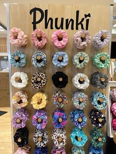 there are many scrunffles on display in the store, and one has a sign that says phunki