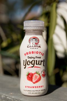 a bottle of yogurt sitting on top of a wooden table