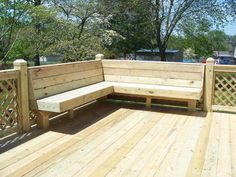 a wooden bench sitting on top of a wooden deck