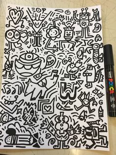 a piece of paper with black and white doodles on it