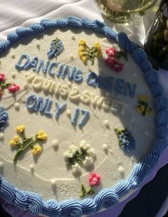 a birthday cake with flowers on it and the words'dancing queen, you are seven only 17 '