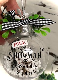 a glass ornament with a free snowman astmly required on it