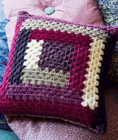 a crocheted pillow with a stuffed animal on it