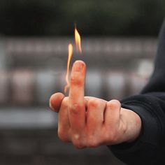 a person holding out their hand with a lit match in the middle