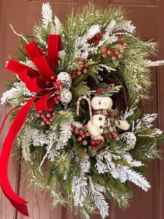 a christmas wreath with a teddy bear on it