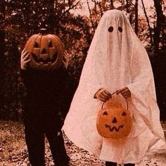 two people dressed up as ghost and pumpkins