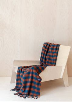 a blanket sitting on top of a wooden bench