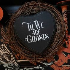 a heart shaped box with the words we are ghosts written on it next to other halloween decorations