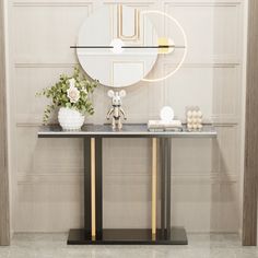 a table with a mirror, vase and flowers on it in front of a wall