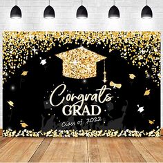 congratulations card with gold confetti and graduation cap on the front in black background