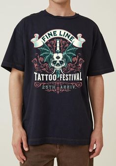 Celebrate the art of ink with the Fine Line Tattoo Festival shirt! This design features a striking skull with bat wings, intricately framed by ornate detailing, and highlights the 25th Anniversary of the tattoo festival. With its classic tattoo-inspired look, this sweatshirt is perfect for those who love tattoo culture and want to showcase their passion through fashion. Whether you're attending a tattoo event or just want a unique piece for your collection, this pullover is an ideal addition to Festival Graphic Print T-shirt Relaxed Fit, Music Festival T-shirt With Screen Print, Black Text Print T-shirt For Music Festival, Music Festival T-shirt With Screen Print, Short Sleeve, Music Festival Cotton T-shirt With Front Print, Festival T Shirts, Classic Tattoo, Festival Shirts, Fine Line Tattoos