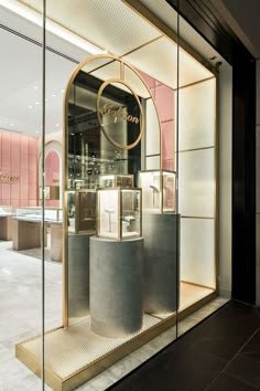 the entrance to a luxury jewelry store with gold trimmings and glass doors that are open