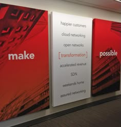 three red and white banners on the wall in an office building with information about how to use it