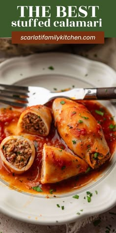 the best stuffed calamari recipe on a white plate with a fork and knife