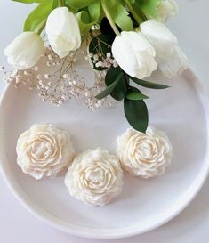 white flowers and greenery on a plate