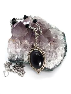 Made to Order! Great for lovers of mourning jewelry, this necklace is suitable for every day wear. Its classic, refined look makes it appropriate even for situations with strict dress coding, but it also makes an appealing addition to your gothic wardrobe. The black cat's eye glass cabochon adds an elegant Gothic Victorian feel to your look. This glass cabochon is set in a bezel and accompanied by matching handmade stainless steel chain links. The remainder of the dainty chain is stainless steel Gothic Jewelry Necklaces Dainty, Spring Goth Necklace, April Goth Necklace, Summer Goth Necklace, Gothic Wardrobe, Goth Subculture, Goth Necklace, Cabochon Necklace, Elegant Gothic