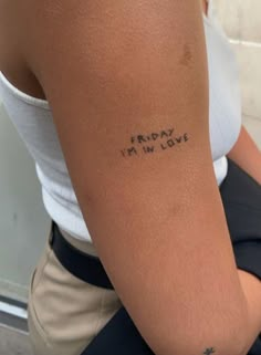 a woman's arm with the words friday i'm in love written on it