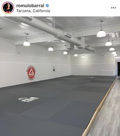 an empty gym with hard wood flooring and white walls is pictured on instagram