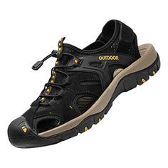 a black shoe with yellow laces on the side and an outstep at the bottom