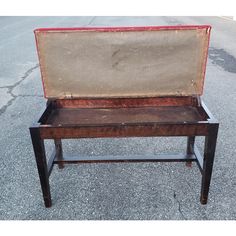 an old suitcase sitting on top of a wooden table in the middle of a parking lot