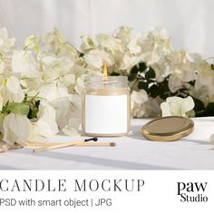 a candle and some flowers on a table with the words candle mockup psd with smart object jpg