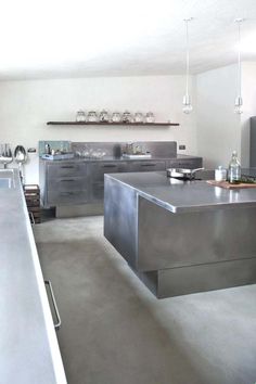 an industrial style kitchen with stainless steel counter tops