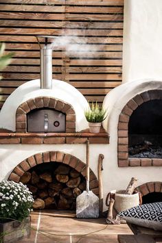 an outdoor pizza oven with wood burning in it