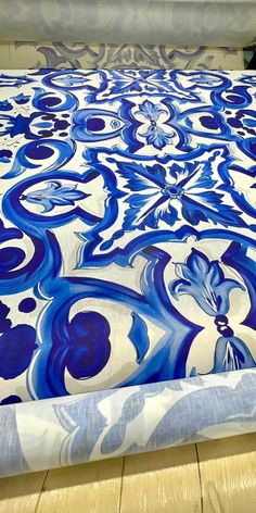 a bed with blue and white designs on it