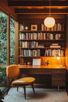 a room with a desk, chair and bookshelf full of books in it