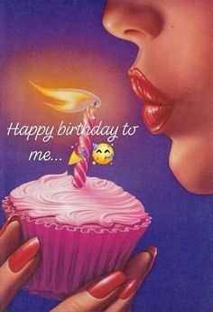 a woman blowing out candles on a cupcake with the words happy birthday to me