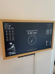 a black and white clock mounted to the side of a wall