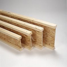 four pieces of plywood are lined up on a white surface with one piece missing