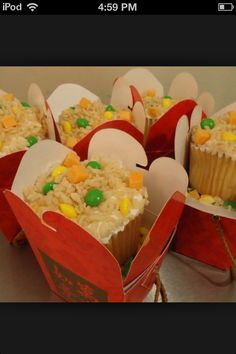 some cupcakes with candy in them are sitting on top of each other and wrapped in paper