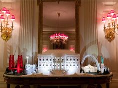 a white table with red and gold decorations on it