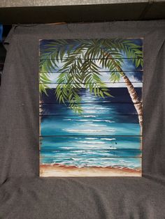 a piece of art that looks like a painting on wood with palm trees in the background