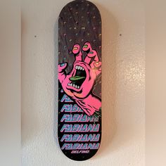 a skateboard hanging on the wall with an image of a hand holding up a fist