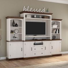 a white entertainment center with built in shelves