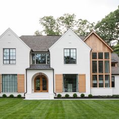 a large white house with brown shutters and windows