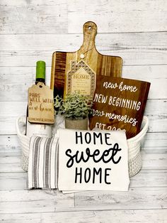 a basket filled with assorted items on top of a white wooden floor next to a sign that says home sweet home