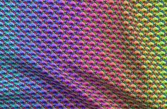 an image of colorful fabric that looks like it has been woven