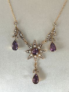 Superb attractive Victorian 9ct gold Amethyst and Pearl Necklace. Very beautiful antique necklace with four large amethyst stones surrounded by pearls and floral motifs, leaves and drops. Very pretty necklace in absolutely excellent condition Marked 9ct. Weight 6.3 grams. Length 22 Inches - 55 cms.   Please Check Sizes And Weights As JEWELLERY IMAGES ARE ENLARGED. Dark areas are reflections on the gold.  BUY WITH CONFIDENCE: I try to accurately describe my items. I never knowingly mis-sell any item, so please read the description carefully. All items are checked by a professional Jeweller for authenticity; however no certificates are provided. If for any reason the item is found not to be genuine or as described a full refund will be given. So please buy with confidence.  Your jewellery wi Antique Hallmarked Purple Necklaces, Vintage Amethyst Yellow Gold Necklace, Antique Purple Hallmarked Necklaces, Vintage Amethyst Necklace In Yellow Gold, Victorian Style Hallmarked Purple Necklaces, Antique Hallmarked Purple Necklace, Victorian Hallmarked Purple Necklace, Antique Purple Hallmarked Necklace, Layerd Necklace