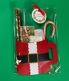 a santa clause bag with candy canes, candies and other holiday items in it