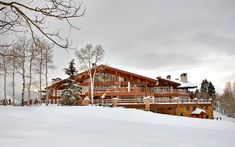 a house in the snow surrounded by trees